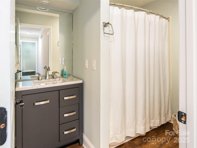 full bath featuring curtained shower, wood finished floors, and vanity