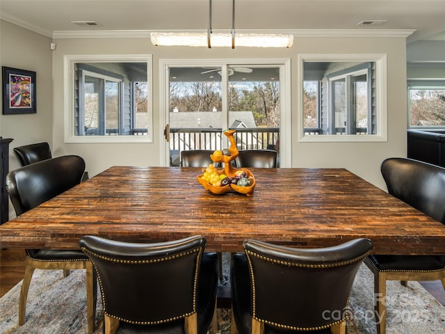 dining area featuring visible vents and crown molding