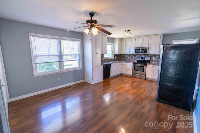 kitchen featuring dark wood finished floors, stainless steel appliances, white cabinets, decorative backsplash, and baseboards