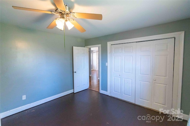 unfurnished bedroom with a ceiling fan, baseboards, and a closet