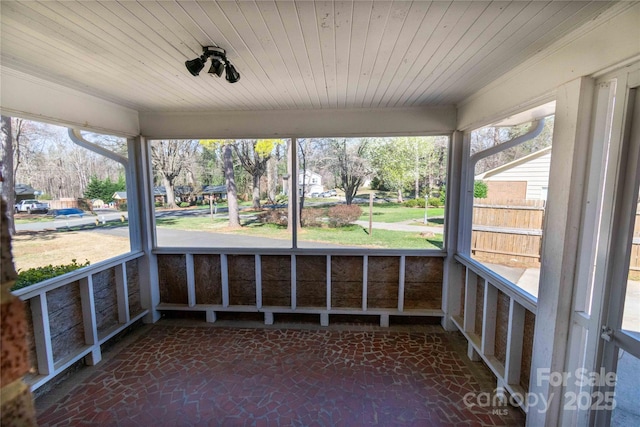 unfurnished sunroom featuring wooden ceiling