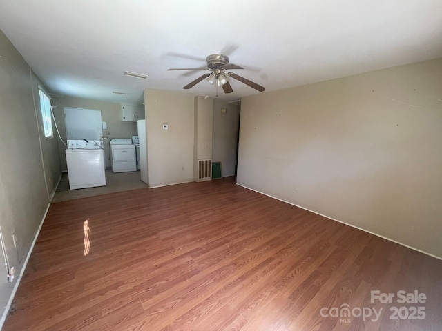 unfurnished living room with visible vents, light wood-style flooring, a ceiling fan, and washer and clothes dryer