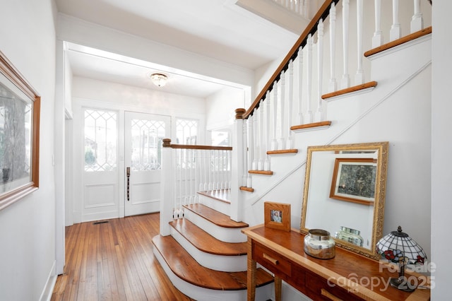 foyer entrance featuring hardwood / wood-style floors and stairs