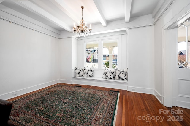 dining area featuring beam ceiling, a notable chandelier, baseboards, and wood finished floors