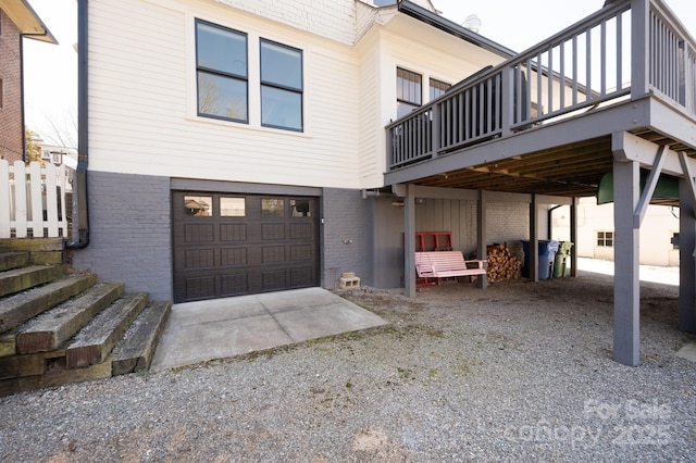 view of side of property featuring brick siding, driveway, and an attached garage