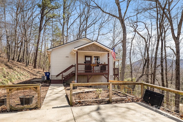 chalet / cabin with a porch and central air condition unit