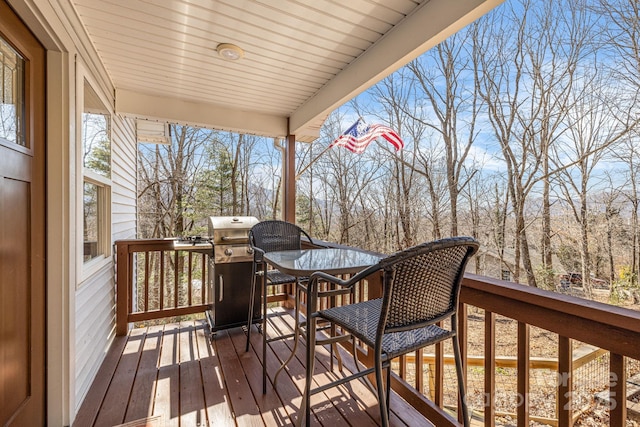 wooden deck featuring a grill