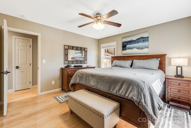 bedroom with light wood-type flooring, baseboards, and ceiling fan