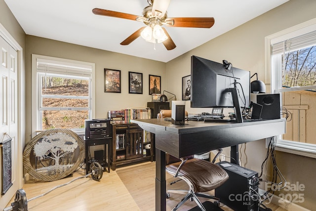 office area featuring a wealth of natural light, a ceiling fan, and wood finished floors