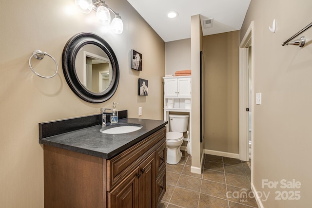 bathroom with visible vents, baseboards, toilet, tile patterned floors, and vanity