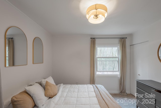 bedroom with light carpet and baseboards