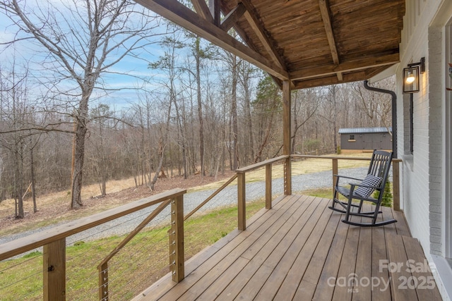 wooden deck featuring a view of trees