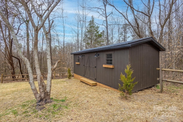 view of shed featuring fence