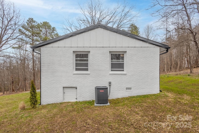 view of home's exterior with a yard, brick siding, central AC, and crawl space