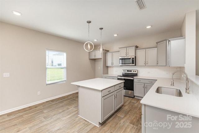 1120 Freeman View Dr, Albemarle, NC 28001 - kitchen featuring appliances with stainless steel finishes, gray cabinets, a sink, decorative backsplash, and recessed lighting