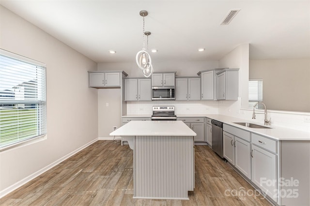 1120 Freeman View Dr, Albemarle, NC 28001 - kitchen featuring a sink, appliances with stainless steel finishes, gray cabinets, tasteful backsplash, and recessed lighting