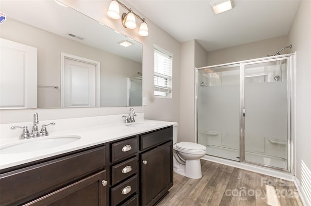 1120 Freeman View Dr, Albemarle, NC 28001 - bathroom featuring a shower stall, wood finished floors, double vanity, and toilet