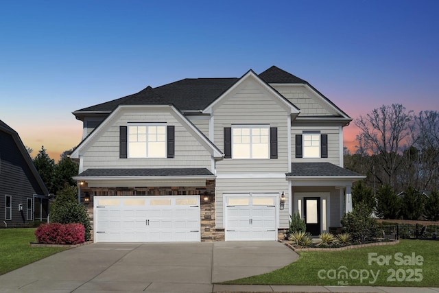 8310 Sandstone Crest Ln, Indian Land, SC 29707 - craftsman house featuring a yard, an attached garage, driveway, and stone siding