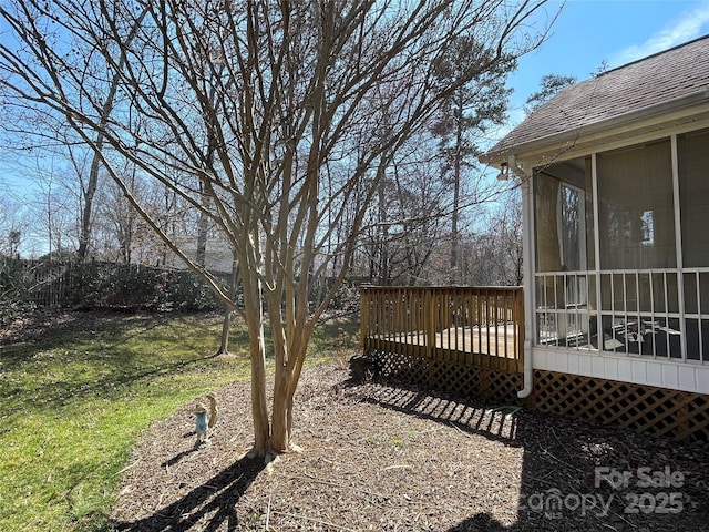 view of yard with a deck and a sunroom