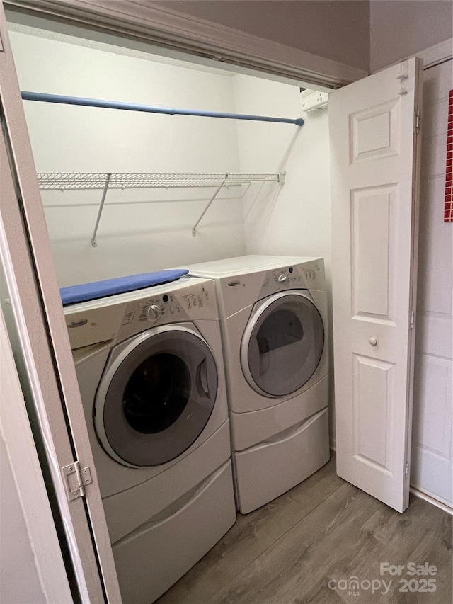 washroom with laundry area, light wood-style flooring, and independent washer and dryer