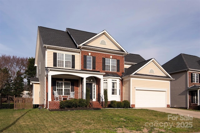 traditional home with fence, covered porch, concrete driveway, a front yard, and an attached garage