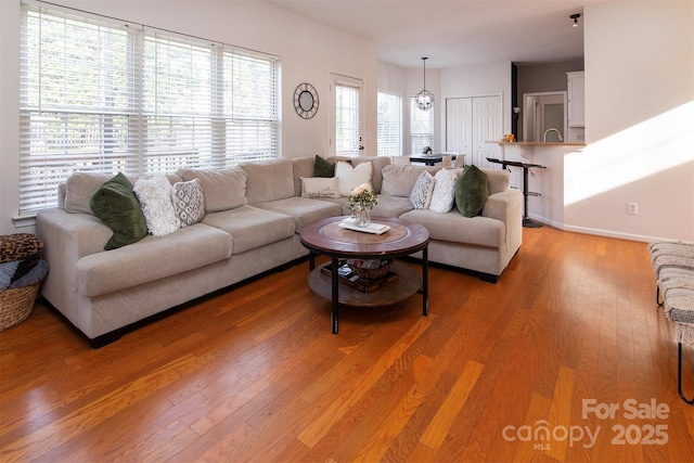 living room featuring baseboards and light wood-style floors