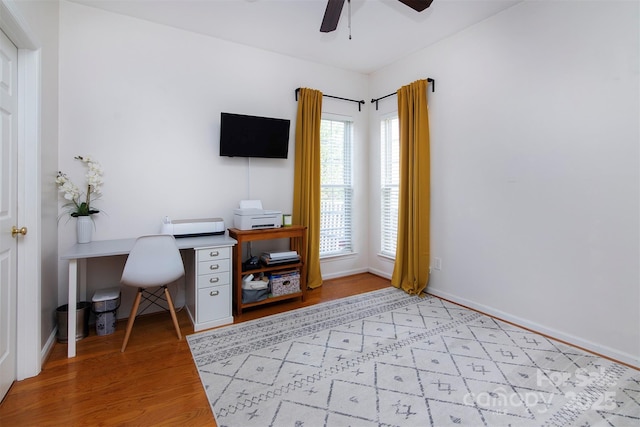 office featuring baseboards, wood finished floors, and ceiling fan