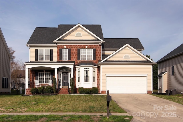 traditional-style house featuring driveway, covered porch, a front yard, a garage, and brick siding