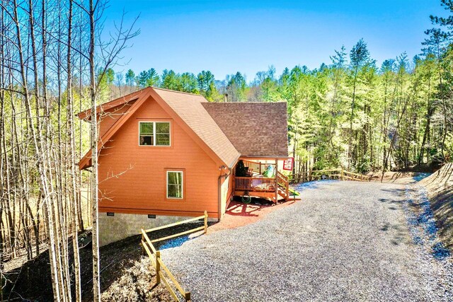 6033 Low Country Rd, Lenoir, NC 28645 - rear view of house featuring a wooded view, a deck, and roof with shingles
