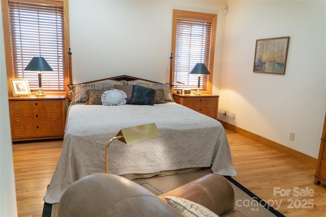 bedroom with baseboards and light wood finished floors