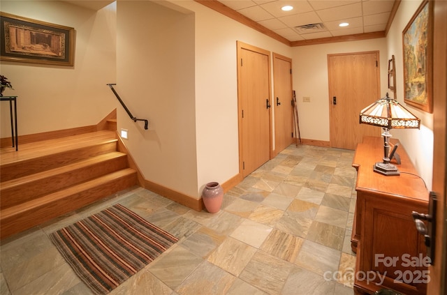 hall with visible vents, baseboards, a drop ceiling, stairs, and recessed lighting