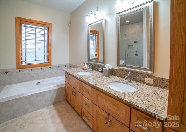 bathroom with a sink, a garden tub, a shower stall, and tile patterned flooring