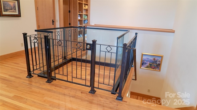 stairs featuring baseboards and wood finished floors