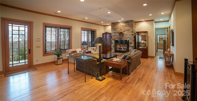 living room with a stone fireplace, light wood-style flooring, plenty of natural light, and baseboards