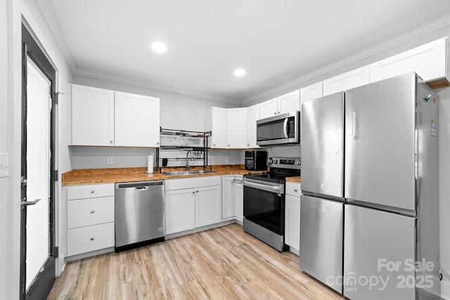 2318 Knight Dr, Gastonia, NC 28052 - kitchen with a sink, white cabinetry, crown molding, and appliances with stainless steel finishes