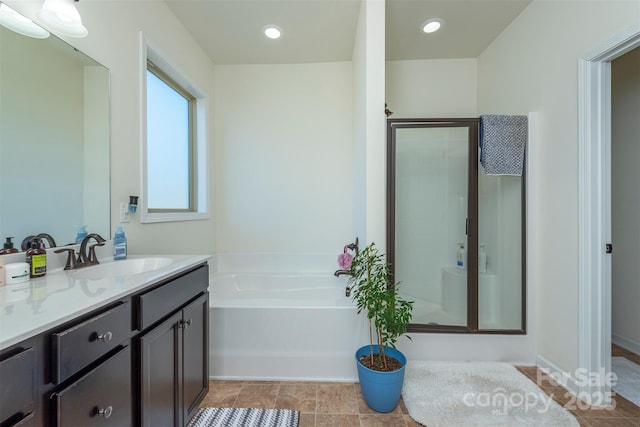 full bath with vanity, a garden tub, recessed lighting, and a stall shower