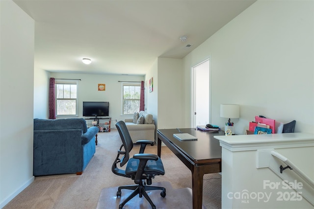 office with visible vents, light colored carpet, and baseboards