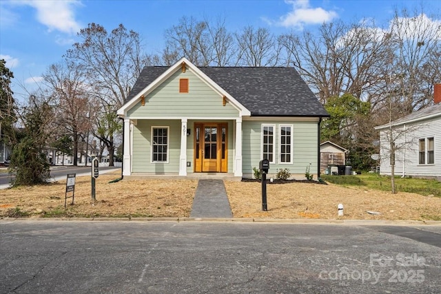 view of front of property featuring a porch and roof with shingles