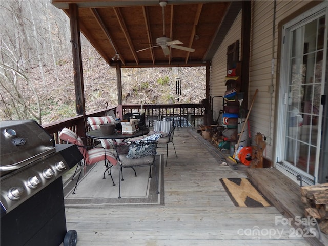 wooden deck with grilling area and ceiling fan