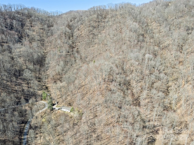 birds eye view of property featuring a view of trees