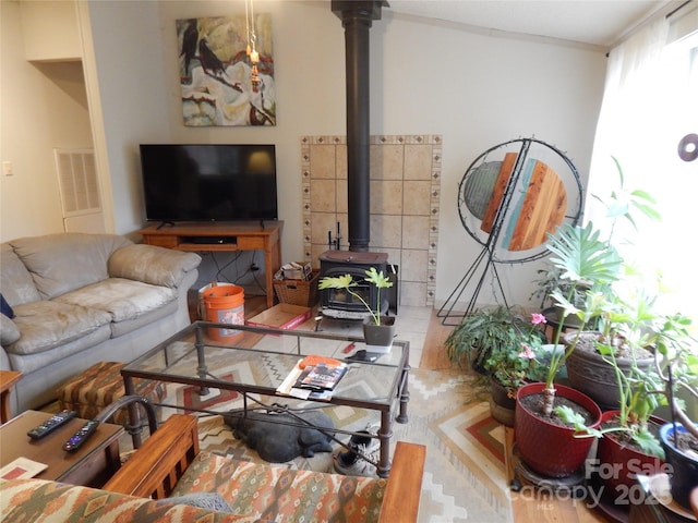 living room with visible vents and a wood stove