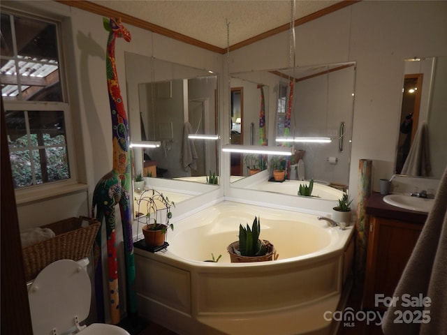 full bath with a textured ceiling, a bath, vanity, and vaulted ceiling