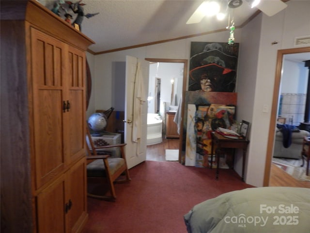 carpeted bedroom featuring visible vents, crown molding, lofted ceiling, ensuite bathroom, and a textured ceiling