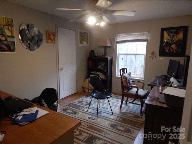 home office featuring light wood-style floors and a ceiling fan