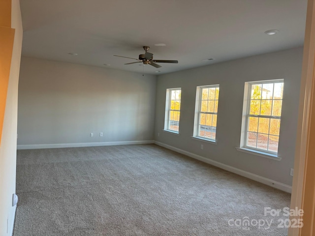 carpeted spare room with recessed lighting, a ceiling fan, and baseboards