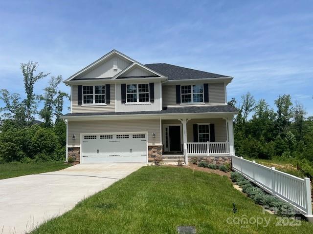 121 High Rock Ct Unit 08, Statesville, NC 28677 - view of front of home with a garage, covered porch, driveway, and stone siding