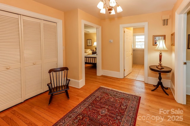 corridor with light wood-style flooring and baseboards
