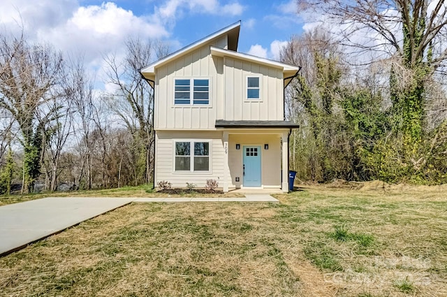 view of front of house with a front yard and board and batten siding