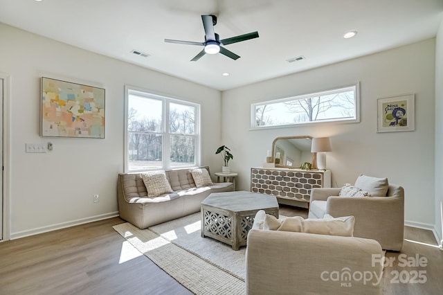 living area with visible vents, a ceiling fan, wood finished floors, recessed lighting, and baseboards