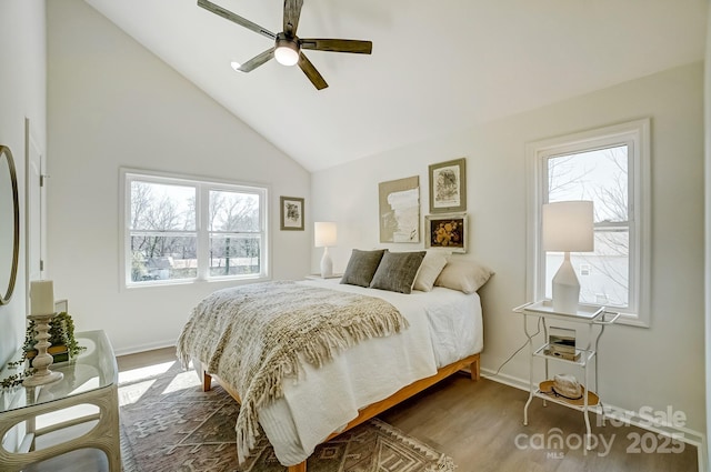 bedroom featuring baseboards, lofted ceiling, dark wood-type flooring, and ceiling fan